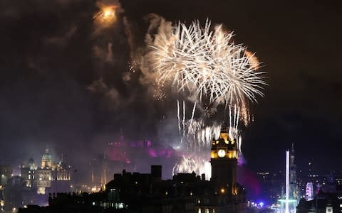 Fireworks light up the sky in Edinburgh during the Hogmanay New Year celebrations - Credit: PA