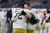 Notre Dame offensive lineman Robert Hainsey (72) and offensive lineman Tommy Kraemer, right, greet each other on the field after their 31-14 loss to Alabama in the Rose Bowl NCAA college football game in Arlington, Texas, Friday, Jan. 1, 2021. (AP Photo/Michael Ainsworth)
