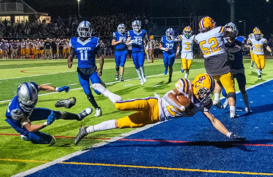 Bay Path’s Bradyn Downes loses a shoe as he dives into the end zone.