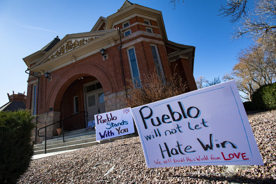 FILE - In this Nov. 5, 2019, file photo, signs, flowers and candles expressing love for the Jewish community stand outside the Temple Emanuel in Pueblo, Colo. Richard Holzer, 28, was sentenced to nearly 20 years in prison on Friday, Feb. 26, 2021, for plotting to bomb the Colorado synagogue last year, by a judge who described the case as "dripping with Nazism and supremacy." (Christian Murdock/The Gazette via AP, File)