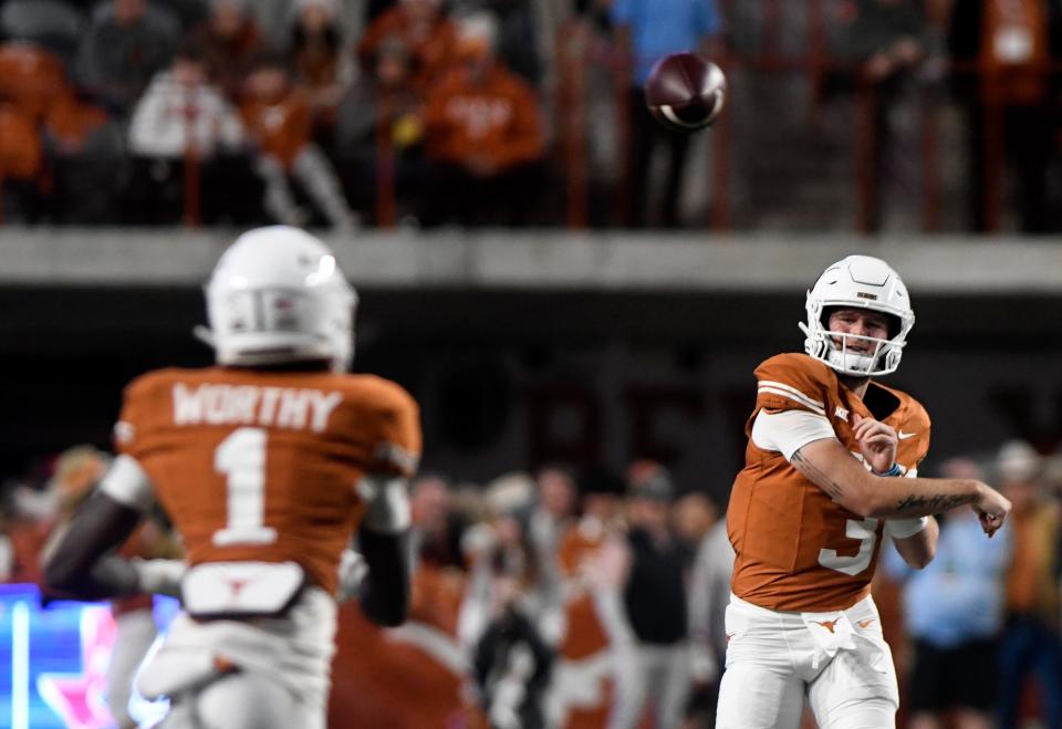 Texas' quarterback Quinn Ewers (3) throws the ball to Texas' wide receiver Xavier Worthy (1) during the game against Texas Tech, Friday, Nov. 24, 2023, at Darrell K. Royal-Texas Memorial Stadium in Austin.