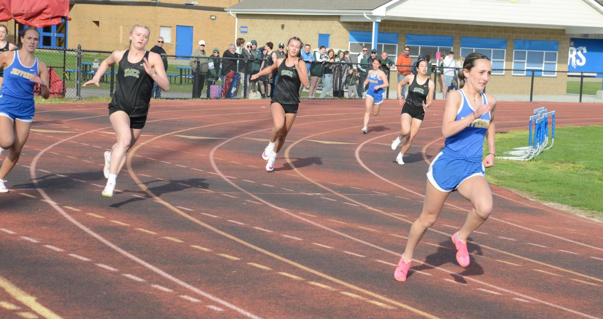 Katie Powell of Jefferson leads the pack in the 200 meters in a dual meet against St. Mary Catholic Central on April 16. She won three individual events and ran on a winning relay as the Bears knocked off three Huron League foes Tuesday.