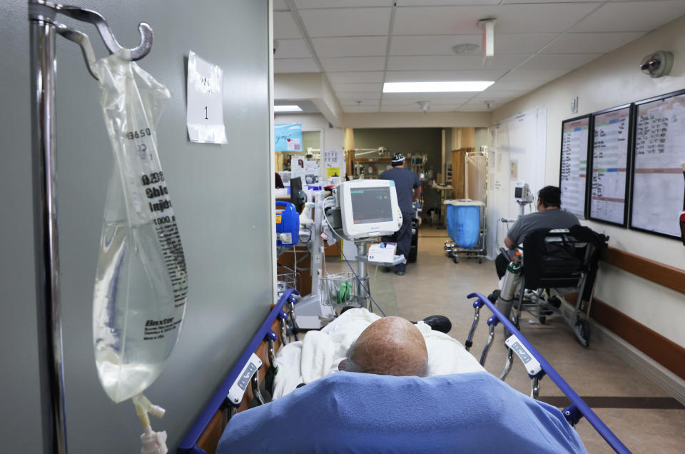 APPLE VALLEY, CALIFORNIA - JANUARY 27: Patients rest in a hallway in the overloaded Emergency Room area at Providence St. Mary Medical Center on January 27, 2021 in Apple Valley, California. (Photo by Mario Tama/Getty Images) 