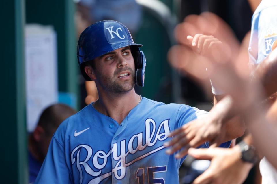 Kansas City Royals’ Whit Merrifield celebrates in the dugout after scoring from third on a hit by Salvador Perez in the first inning of a baseball game at Kauffman Stadium in Kansas City, Mo., Wednesday, Aug. 11, 2021. (AP Photo/Colin E. Braley)