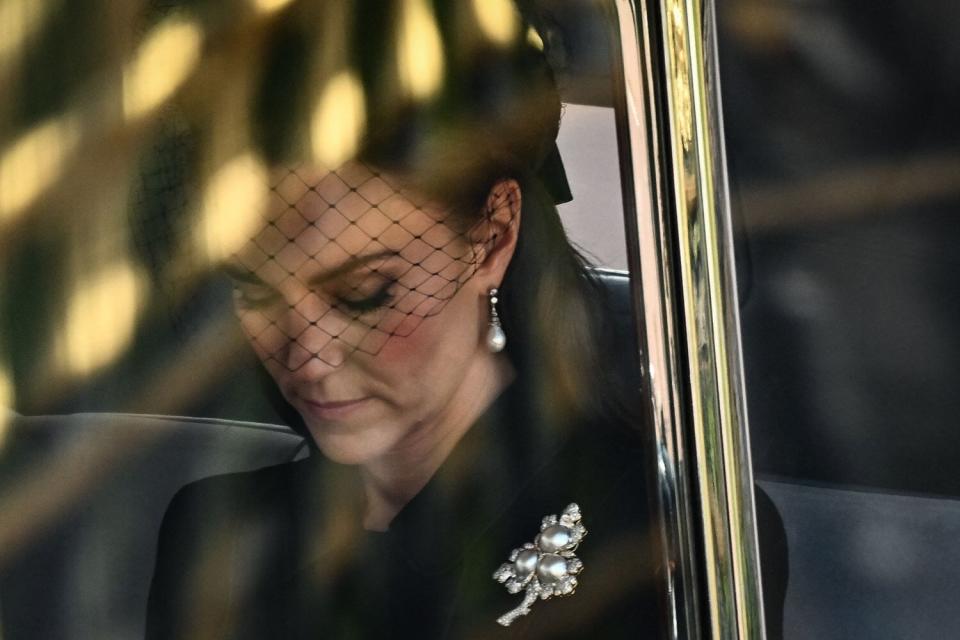 Catherine, Princess of Wales is driven behind the coffin of Queen Elizabeth II, adorned with a Royal Standard and the Imperial State Crown and pulled by a Gun Carriage of The King's Troop Royal Horse Artillery