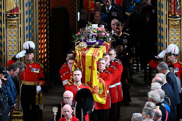 LONDON, ENGLAND - SEPTEMBER 19: The coffin of Queen Elizabeth II with the Imperial State Crown resting on top departs Westminster Abbey during the State Funeral of Queen Elizabeth II on September 19, 2022 in London, England. Elizabeth Alexandra Mary Windsor was born in Bruton Street, Mayfair, London on 21 April 1926. She married Prince Philip in 1947 and ascended the throne of the United Kingdom and Commonwealth on 6 February 1952 after the death of her Father, King George VI. Queen Elizabeth II died at Balmoral Castle in Scotland on September 8, 2022, and is succeeded by her eldest son, King Charles III.  (Photo by Gareth Cattermole/Getty Images)