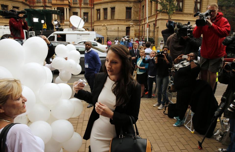 Aimee Pistorius is greeted by a supporter as she arrives for her brother Oscar's trial in Pretoria