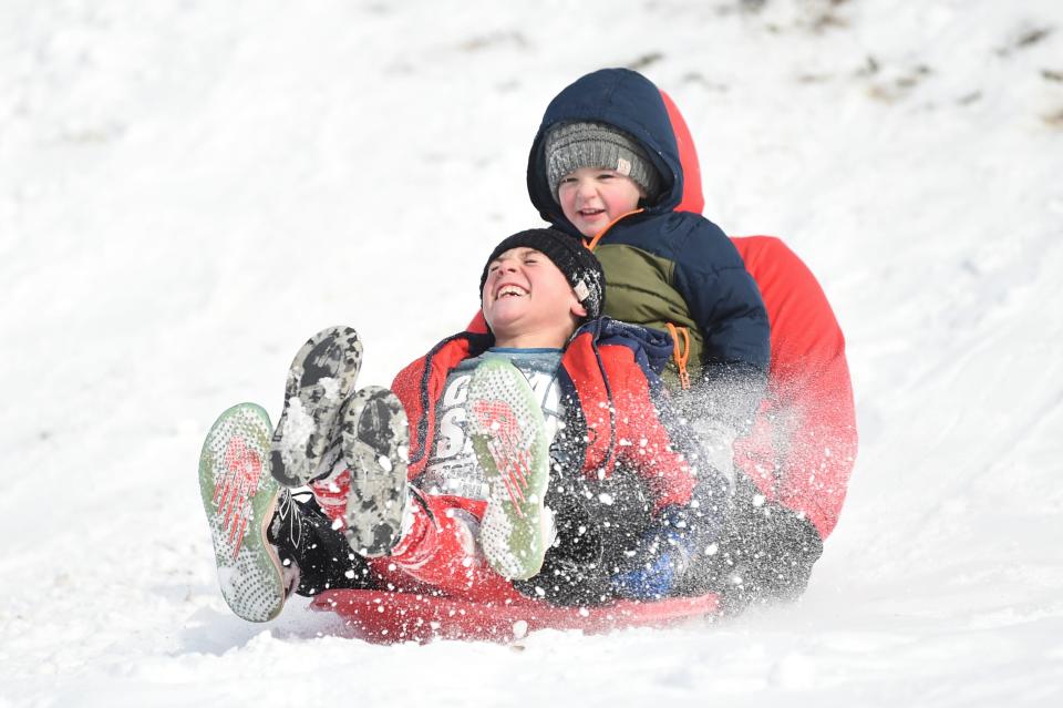 Josh Elliott sleds down a hill at Baker Creek Preserve with his sons Sutton, 4, and Noah, 8, during a snowstorm Jan. 16.