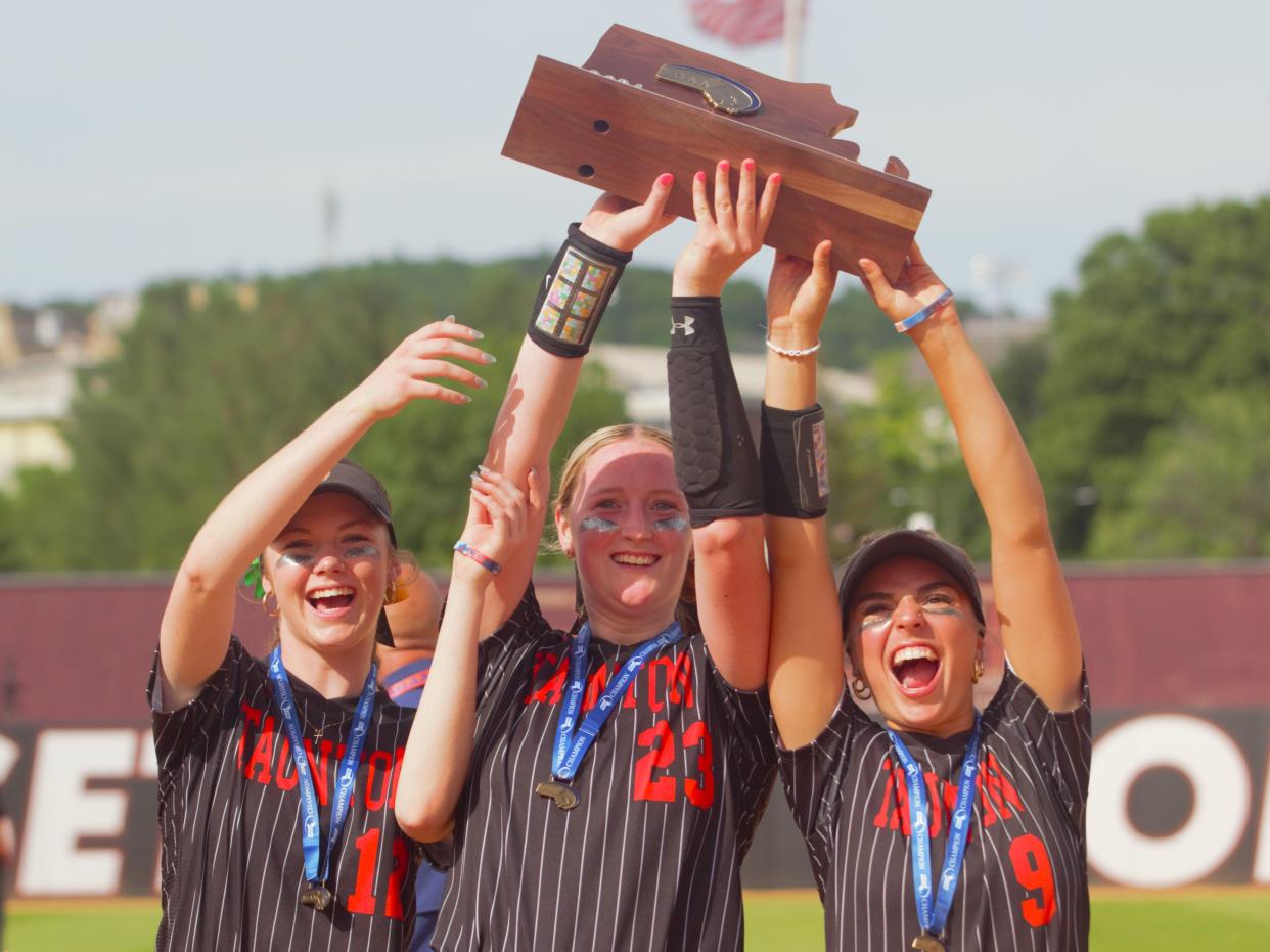 From left to right: Taunton senior captains Bridget MacDougall, Sam Lincoln and Molly Carnes hoist the 2024 MIAA Division 1 championship trophy after beating King Philip for their fourth straight title.