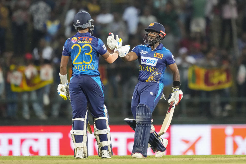 Sri Lanka's Sadeera Samarawickrama, left, and Charith Asalanka cheer eachothers during the one day international cricket match between Sri Lanka and Bangladesh of Asia Cup in Pallekele, Sri Lanka on Thursday, Aug. 31. (AP Photo/Eranga Jayawardena)