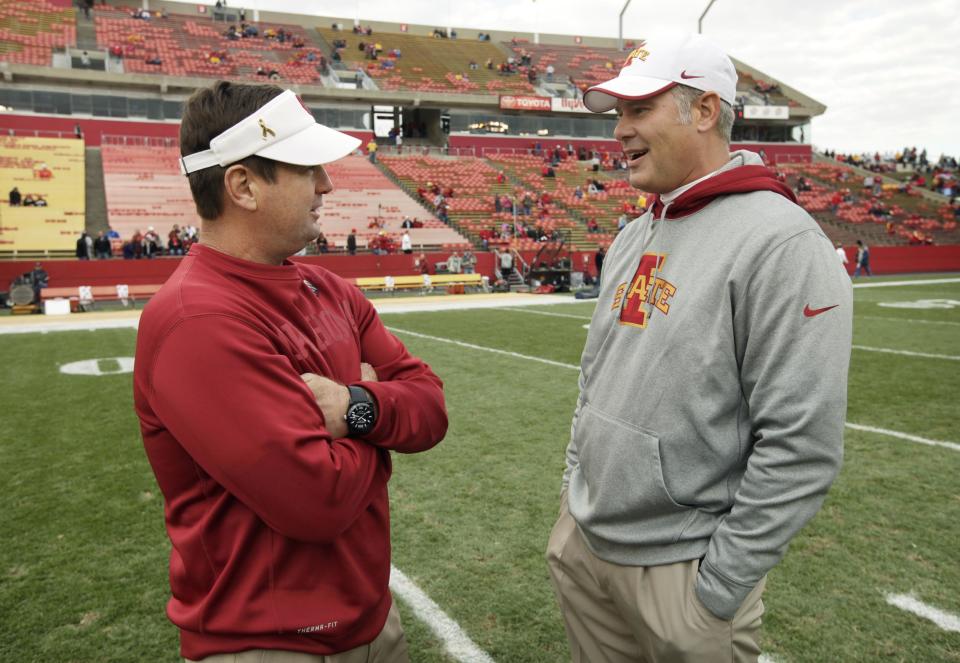 Oklahoma head coach Bob Stoops, left, talks with Iowa State head coach Paul Rhoads before an NCAA college football game, Saturday, Nov. 3, 2012, in Ames, Iowa. (AP Photo/Charlie Neibergall)