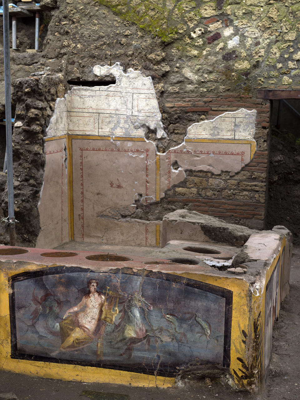 An undated photo made available by the Pompeii Archeological park press office shows the thermopolium in the Pompeii archeological park, near Naples, Italy. A fast-food eatery discovered at Pompeii is now completely excavated, helping to reveal some favorite dishes of citizens of the ancient Roman city who liked to eat out. Pompeii Archaeological Park’s longtime chief, Massimo Osanna said Saturday, Dec. 26, 2020, in a statement that while some 80 such fast-foods have been found at Pompeii, it is the first time such an eatery — known as a thermopolium since it serve hot foods — had been entirely excavated. (Luigi Spina/Parco Archeologico di Pompei via AP)