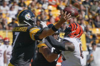 Cincinnati Bengals defensive tackle Larry Ogunjobi (65) hits Pittsburgh Steelers quarterback Ben Roethlisberger (7) as Roethlisberger passes during the second half an NFL football game, Sunday, Sept. 26, 2021, in Pittsburgh. (AP Photo/Gene J. Puskar)