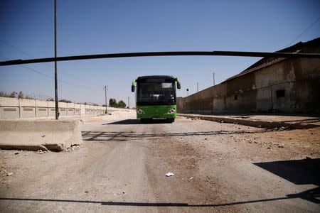 An empty bus that was supposed to evacuate people drives near the entrance of the Waer district in the central Syrian city of Homs, Syria September 19, 2016. REUTERS/Omar Sanadiki