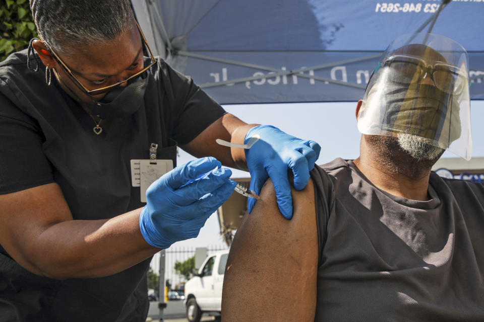 A health worker administers a Pfizer Covid-19 vaccination at a mobile vaccination clinic in Los Angeles on July 16, 2021. (Irfan Khan / Los Angeles Times via Getty Images)