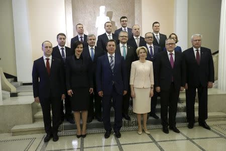 Latvia's Parliament speaker Inara Murniece (3rd R), new Prime Minister Maris Kucinskis (3rd L) and his government members pose for media after their first meeting in Riga, Latvia, February 11, 2016. REUTERS/Ints Kalnins