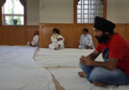 Worshippers attend evening prayer at Gurdwara Millwoods, a Sikh house of worship, in Edmonton, Alberta, on Wednesday, July 20, 2022. (AP Photo/Jessie Wardarski)