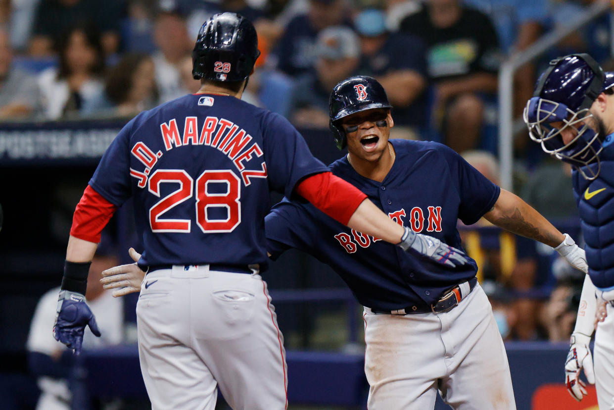 J.D. Martinez of the Boston Red Sox celebrates his three-run homer with Rafael Devers