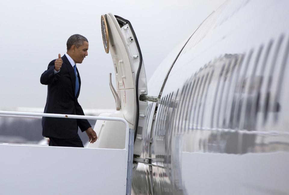 President Barack Obama gives the thumbs up as he boards Air Force One at Andrews Air Force Base, Md., Wednesday, April 2, 2014, en route to the University of Michigan to speak about his proposal to raise the national minimum wage. (AP Photo/Carolyn Kaster)