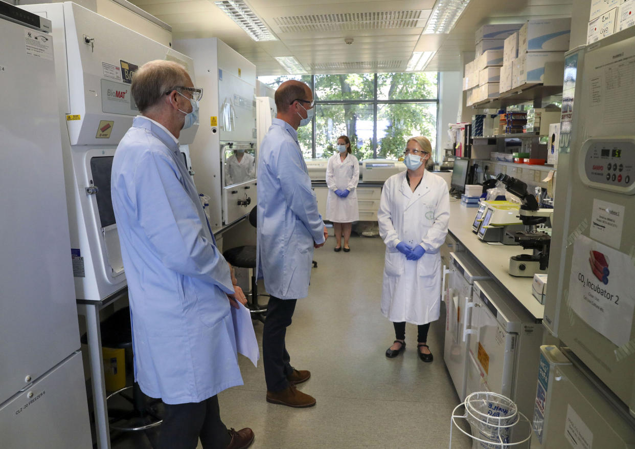 Britain's Prince William, center, wears a mask as he meets scientists during a visit to the manufacturing laboratory where a vaccine against COVID-19 has been produced, at the Oxford Vaccine Group's facility at the Churchill Hospital in Oxford, England, Wednesday, June 24, 2020. The royal was given a tour Wednesday of the manufacturing laboratory where the experimental vaccine has been produced. The trials began Apr.23 and 10,000 people in the U.K are in the process of being vaccinated to assess the potential success of the treatment. (Steve Parsons/Pool photo via AP)