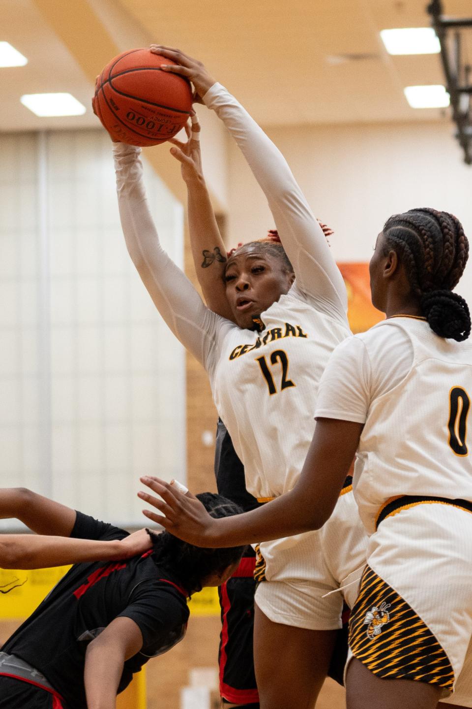 Central's Destiny Jones (12) fights for the rebound against Manual defender during their game on Tuesday, Jan. 23, 2024 at Central High School.