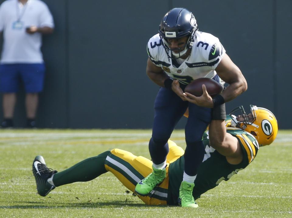 Russell Wilson was pressured most of the game against the Packers on Sunday. (AP)