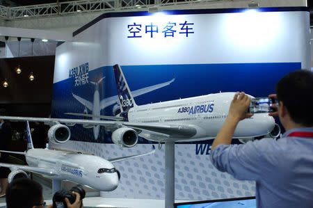 A visitor takes a photo of a model of Airbus A380 plane at Aviation Expo China 2017 in Beijing, China September 19, 2017. REUTERS/Stringer