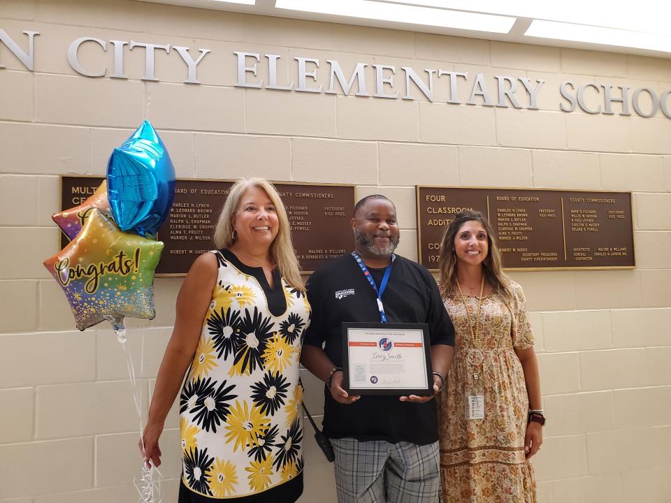 Ocean City Elementary School custodian Ivory Smith, center receives MSEA’s Education Support Professional of the Year honors from MSEA President Cheryl Bost, left, and with them is OCES Principal Julie Smith, who nominated him for the award.