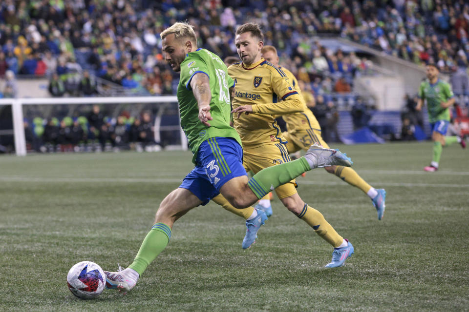 Seattle Sounders forward Jordan Morris (13) drives the ball as Real Salt Lake's Andrew Brody defends during the second half of an MLS soccer match Saturday, March 4, 2023, in Seattle. The Sounders won 2-0. (AP Photo/Jason Redmond)