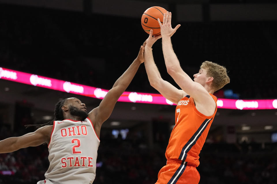 Illinois forward Marcus Domask, right, shoots over Ohio State guard Bruce Thornton (2) in the first half of an NCAA college basketball game Tuesday, Jan. 30, 2024, in Columbus, Ohio. (AP Photo/Sue Ogrocki)