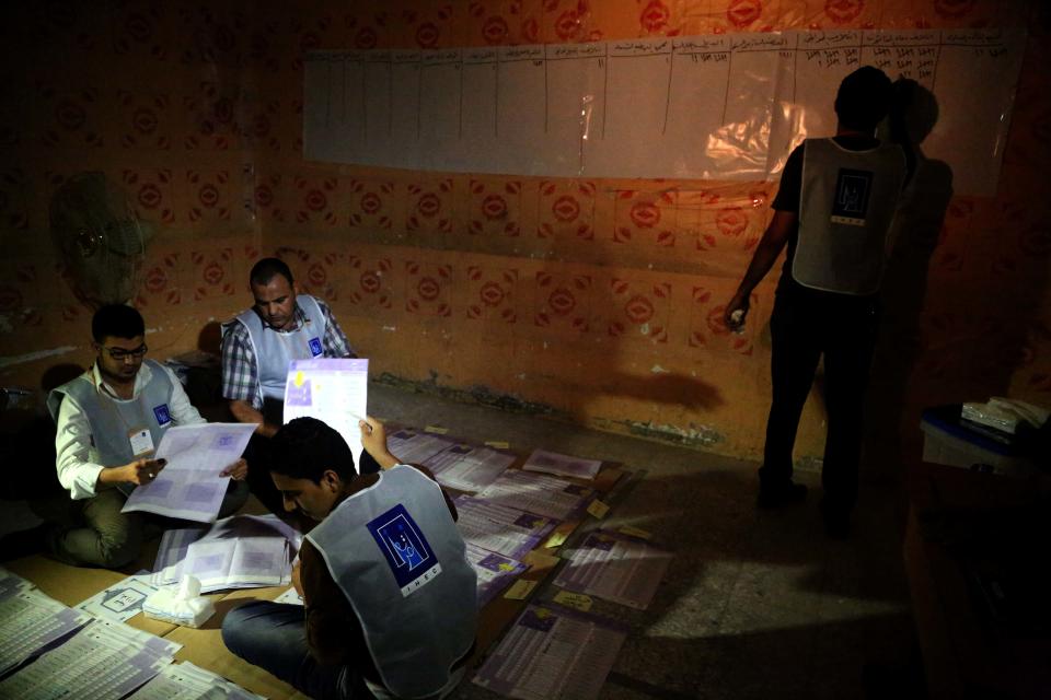 Electoral workers count ballots under lamplight due to a power cut, as polls close at a polling center in Basra, Iraq's second-largest city, 340 miles (550 kilometers) southeast of Baghdad, Iraq, Wednesday, April 30, 2014. Iraqis braved the threat of bombs and other violence to vote Wednesday in parliamentary elections amid a massive security operation as the country slides deeper into sectarian strife. (AP Photo/ Nabil al-Jurani)