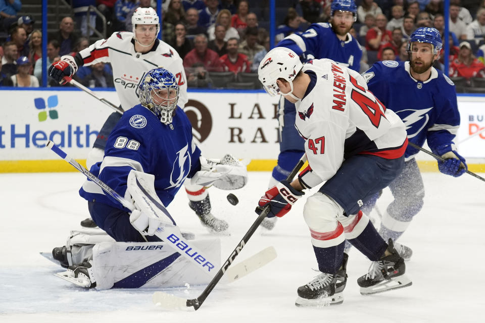 Tampa Bay Lightning goaltender Andrei Vasilevskiy (88) makes a save on a shot by Washington Capitals left wing Beck Malenstyn (47) during the first period of an NHL hockey game Thursday, Feb. 22, 2024, in Tampa, Fla. (AP Photo/Chris O'Meara)