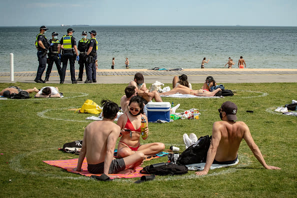 People in Melbourne social distance at the beach.