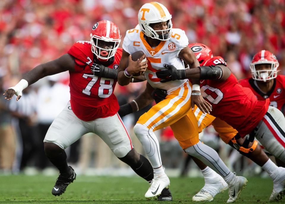 Tennessee quarterback Hendon Hooker (5) is brought down by Georgia defensive lineman Tramel Walthour (90) during Tennessee's game against Georgia at Sanford Stadium in Athens, Ga., on Saturday, Nov. 5, 2022.