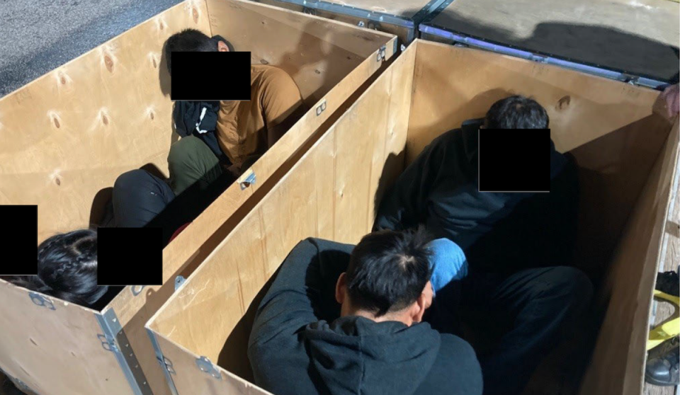 Migrants inside a wooden crate. / Credit: U.S. Department of Justice