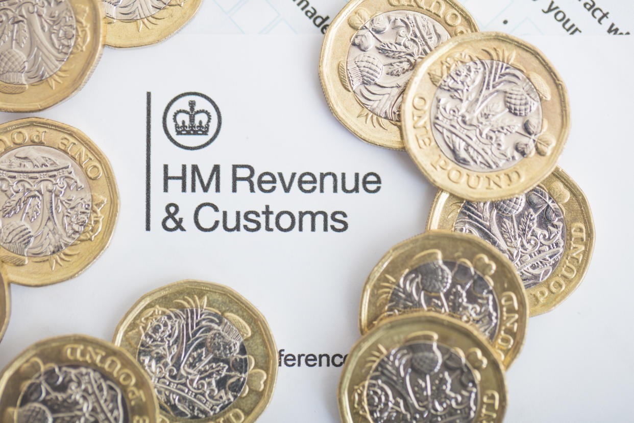 An editorial stock photo of the UK Inland Revenue Tax forms with the new 2017 One Pound Coins.