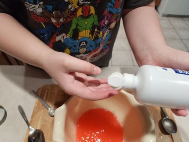 A little contact solution helps keep the slime from sticking to your hands while mixing.