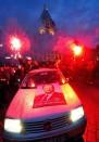 Supporters of France's Socialist Party (PS) newly elected president celebrate with smoke bombs from a car, at the Grande Place in Lille after the announcement of the first official results of the second round of Presidential election