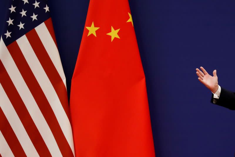 FILE PHOTO: U.S. President Donald Trump delivers his speech as he and China's President Xi Jinping meet business leaders in Beijing