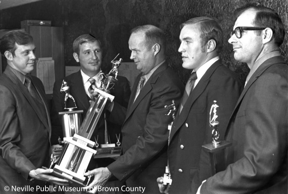 Wisconsin State Baseball League secretary Denny Moyer of Sheboygan presents the championship trophy to Blue Ribbon sponsor Bob Bur in October 1970. Looking on is manager Denny Ruh, left.