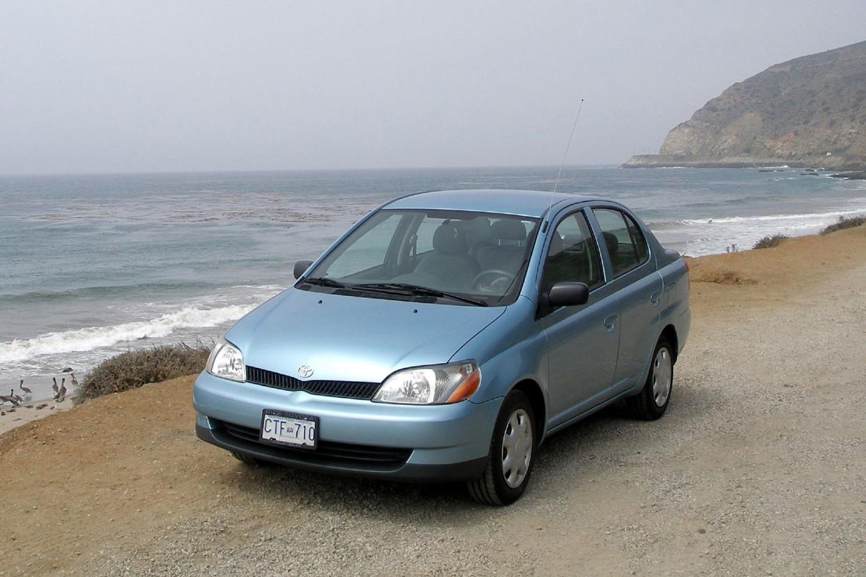 light blue toyota echo on beach