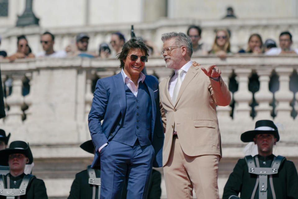 Actor Tom Cruise, left and director Chris McQuarrie pose for photographers on the red carpet of the world premiere for the movie "Mission: Impossible - Dead Reckoning" at the Spanish Steps in Rome Monday, June 19, 2023. (AP Photo/Alessandra Tarantino)