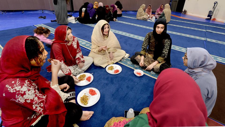 Muslim woman break their fast Saturday after sunset, April 1, 2023, at the Al Noor Community Center in Springfield during Ramadan.