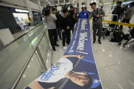 Fans hold a banner showing Los Angeles Dodgers' Shohei Ohtani as they wait for his arrival for the upcoming two games of the MLB World Tour Seoul Series between Los Angeles Dodgers and San Diego Padres, at the Incheon International Airport in Incheon, South Korea, Thursday, March 14, 2024. (AP Photo/Ahn Young-joon)