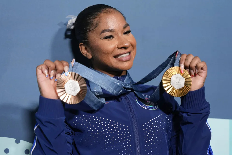 FILE - Jordan Chiles, of the United States, holds up her medals after the women's artistic gymnastics individual apparatus finals Bercy Arena at the 2024 Summer Olympics, Aug. 5, 2024, in Paris, France. (AP Photo/Charlie Riedel, File)