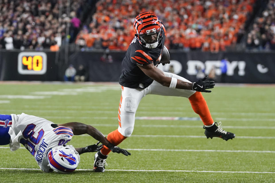 Cincinnati Bengals wide receiver Ja'Marr Chase, right, tries to dodge a tackle attempt by Buffalo Bills cornerback Dane Jackson during the first half of an NFL football game, Sunday, Nov. 5, 2023, in Cincinnati. (AP Photo/Darron Cummings)