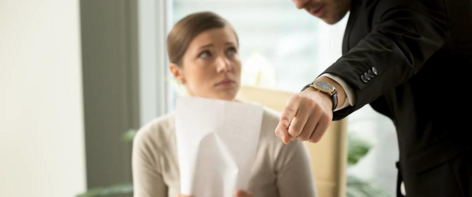 Woman being scolded by male boss