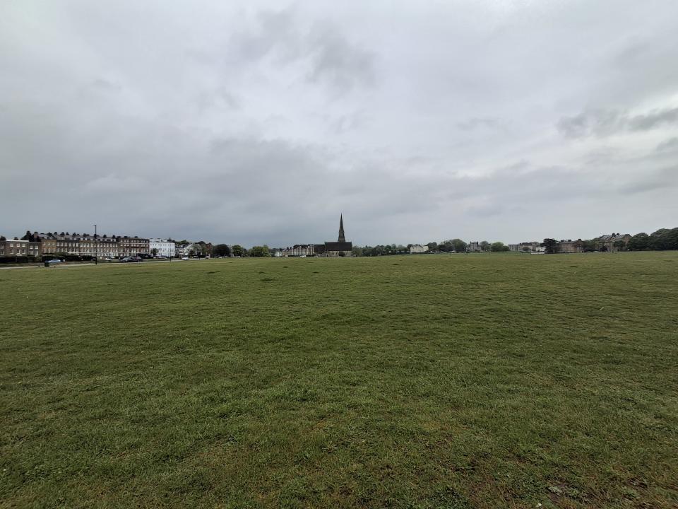 A field with a church taken on the Samsung Galaxy A35