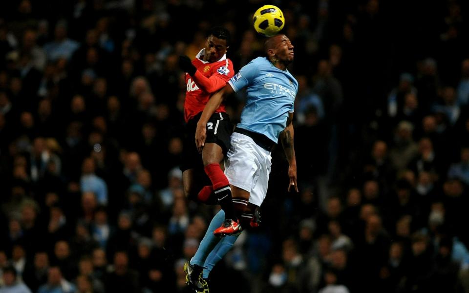 Jerome Boateng competing for the ball with Patrice Evra during the Manchester derby in 2010 - GETTY IMAGES