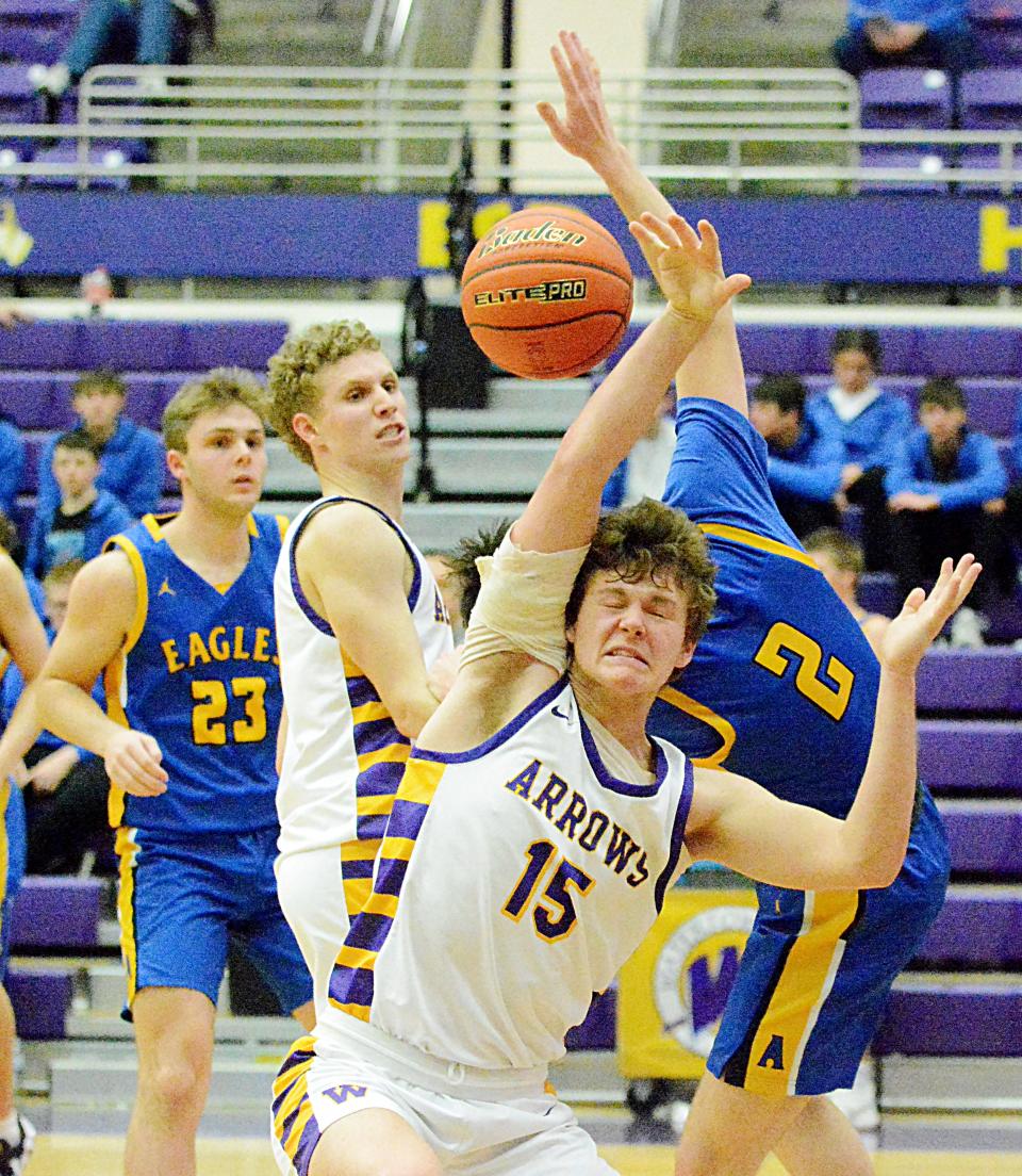 Watertown's Marcus Rabine (15) fights for a rebound with Aberdeen Central's Carter Dingman during their high school boys basketball game on Tuesday, Jan. 10, 2023 in the Watertown Civic Arena. Watertown won 48-30. Looking on are Watertown's Dalton Baumberger and Aberdeen Central's Camden Fauth.